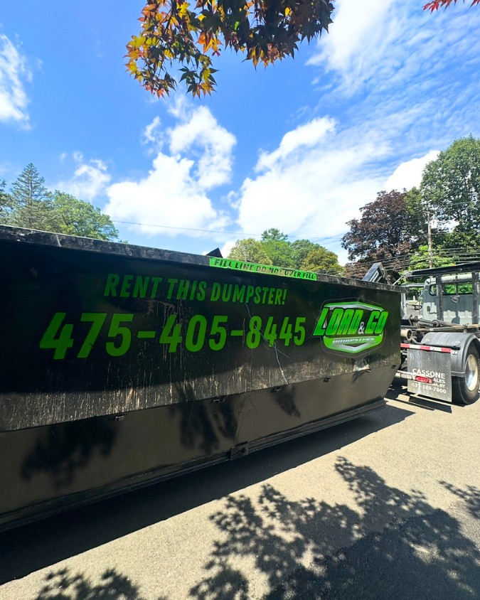 Load & Go Dumpster truck on job site